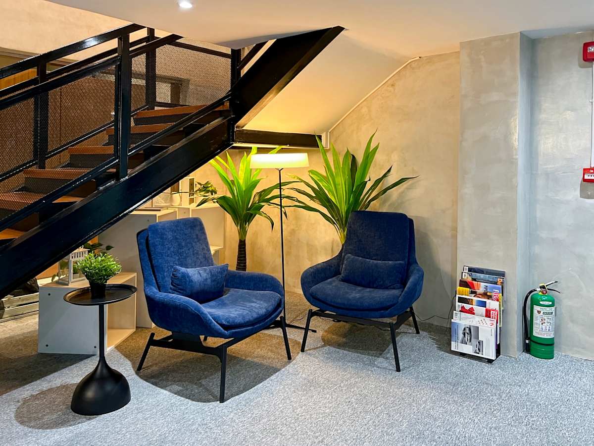Cozy coworking lounge with plush seating and ample lighting on Quezon Avenue. Perfect for meetings.
