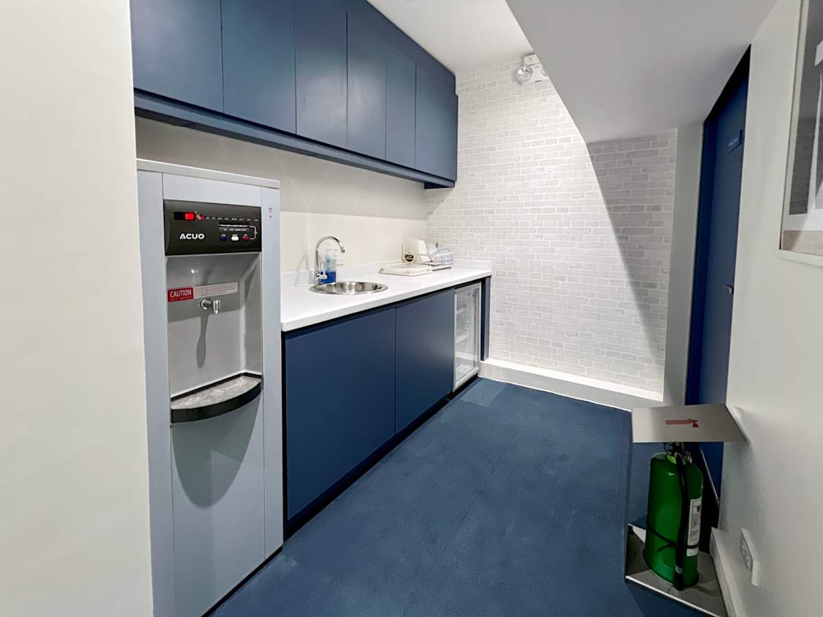 Sleek kitchenette in flexible coworking space on Quezon Avenue, Metro Manila.