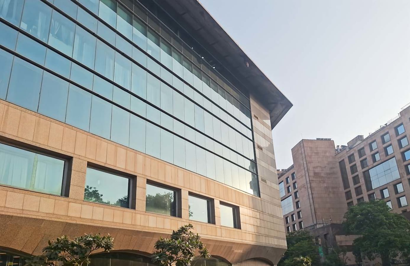 Modern coworking space on Mandir Marg, Delhi, with contemporary architecture and ample natural light.