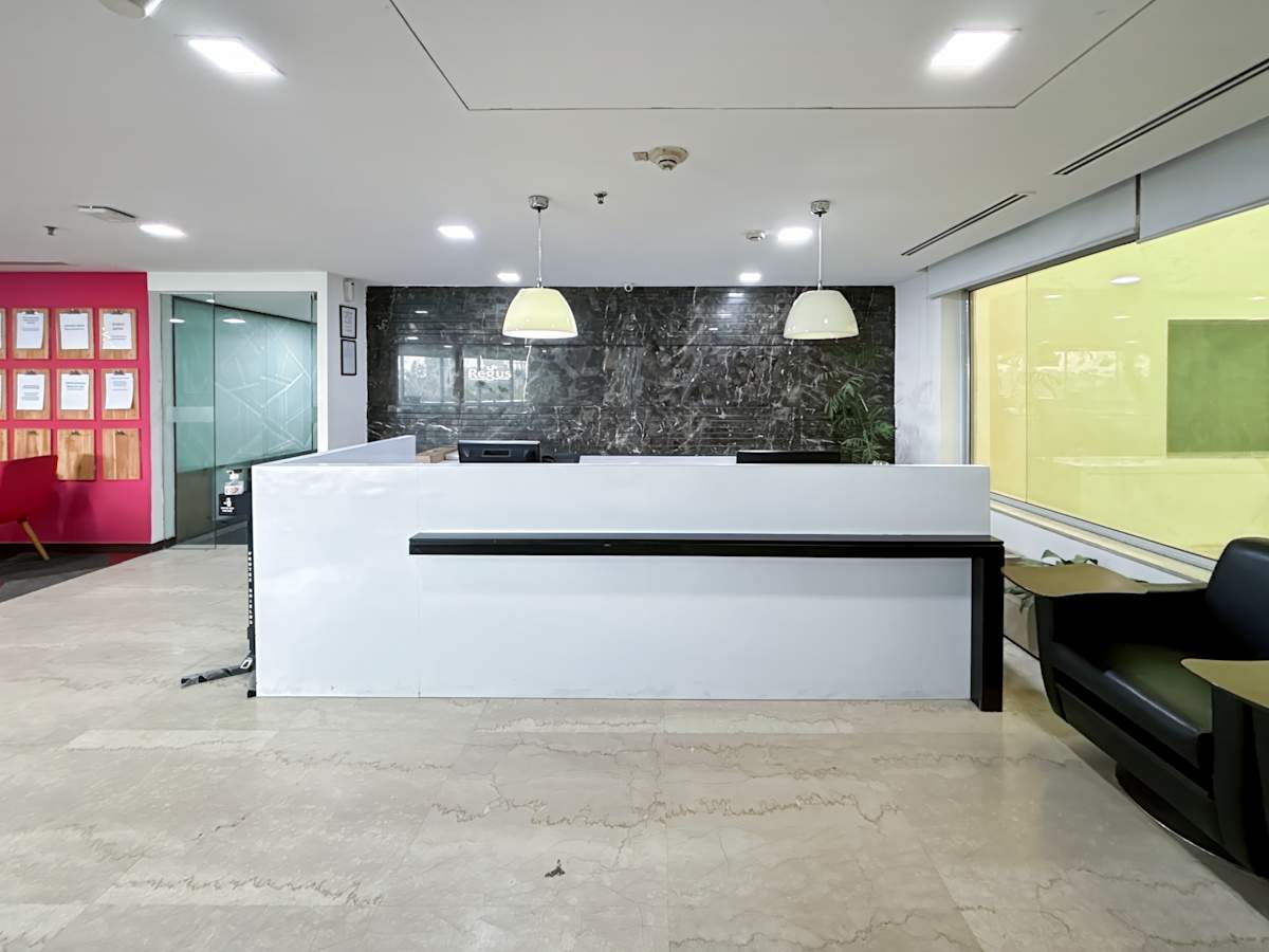 Modern coworking space in Mandir Marg featuring sleek reception and ample natural light.