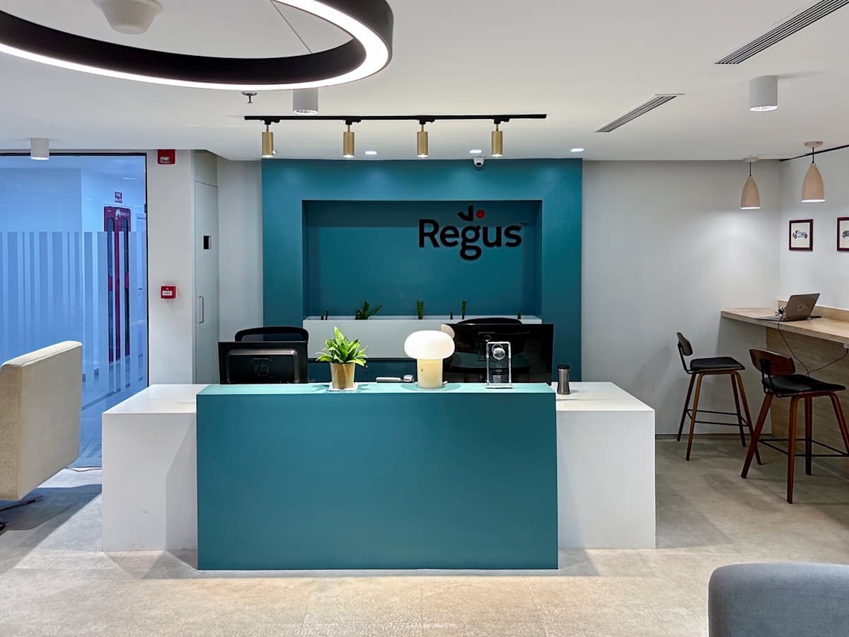 Modern coworking reception area with sleek decor and ambient lighting.