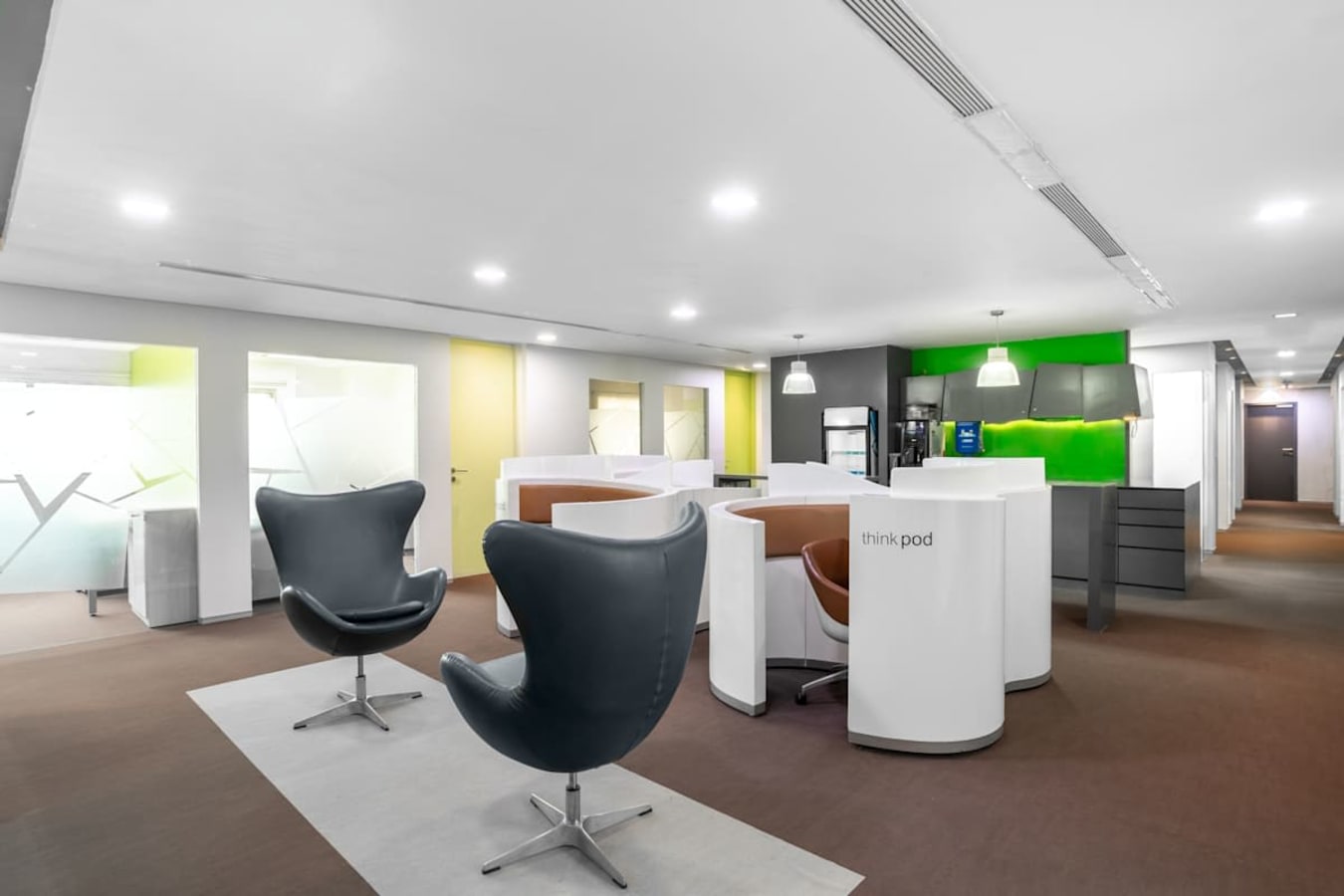 Modern coworking area with sleek chairs and vibrant accents on Harrington Road.