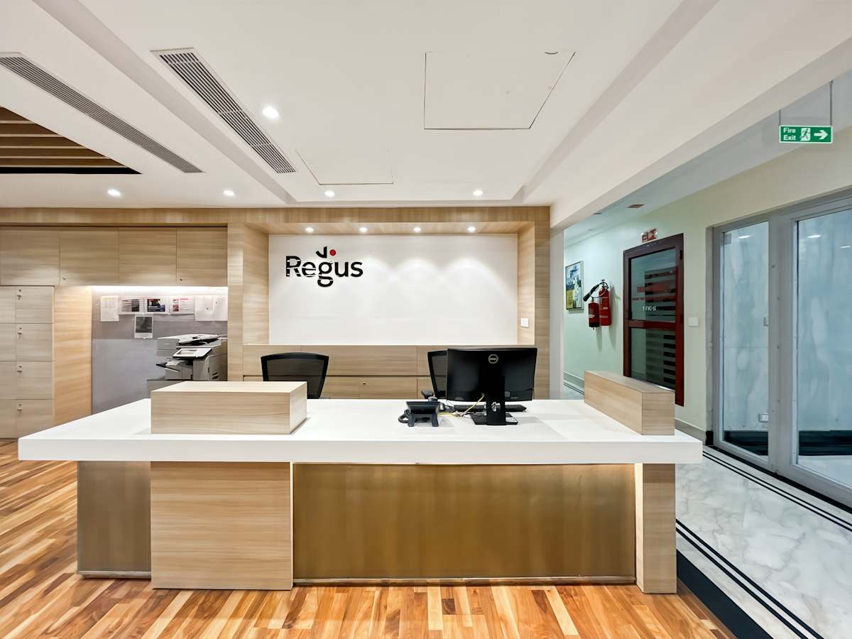 Modern coworking space in New Delhi featuring a sleek reception area with warm wood accents.