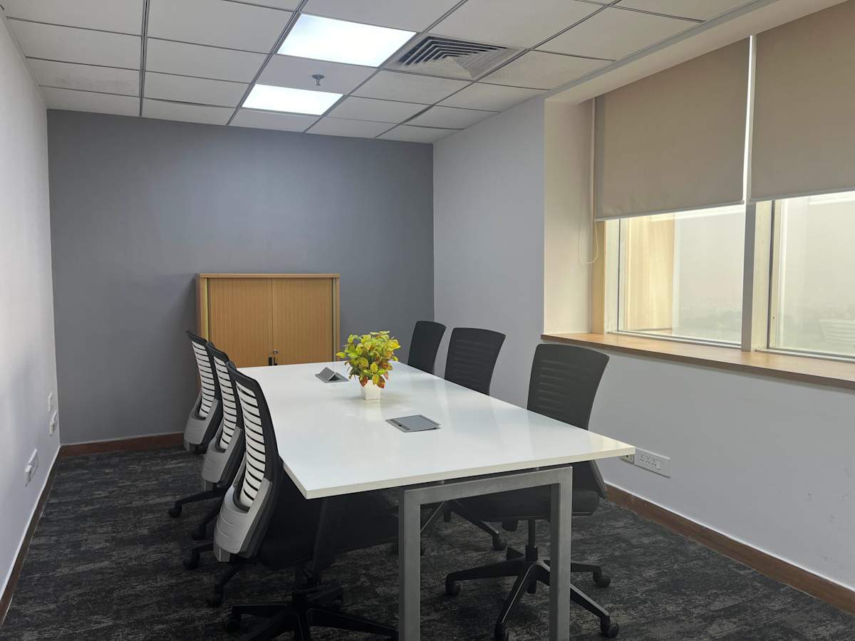 Modern meeting room in New Delhi offers sleek design and ample natural light. Ideal for collaboration.