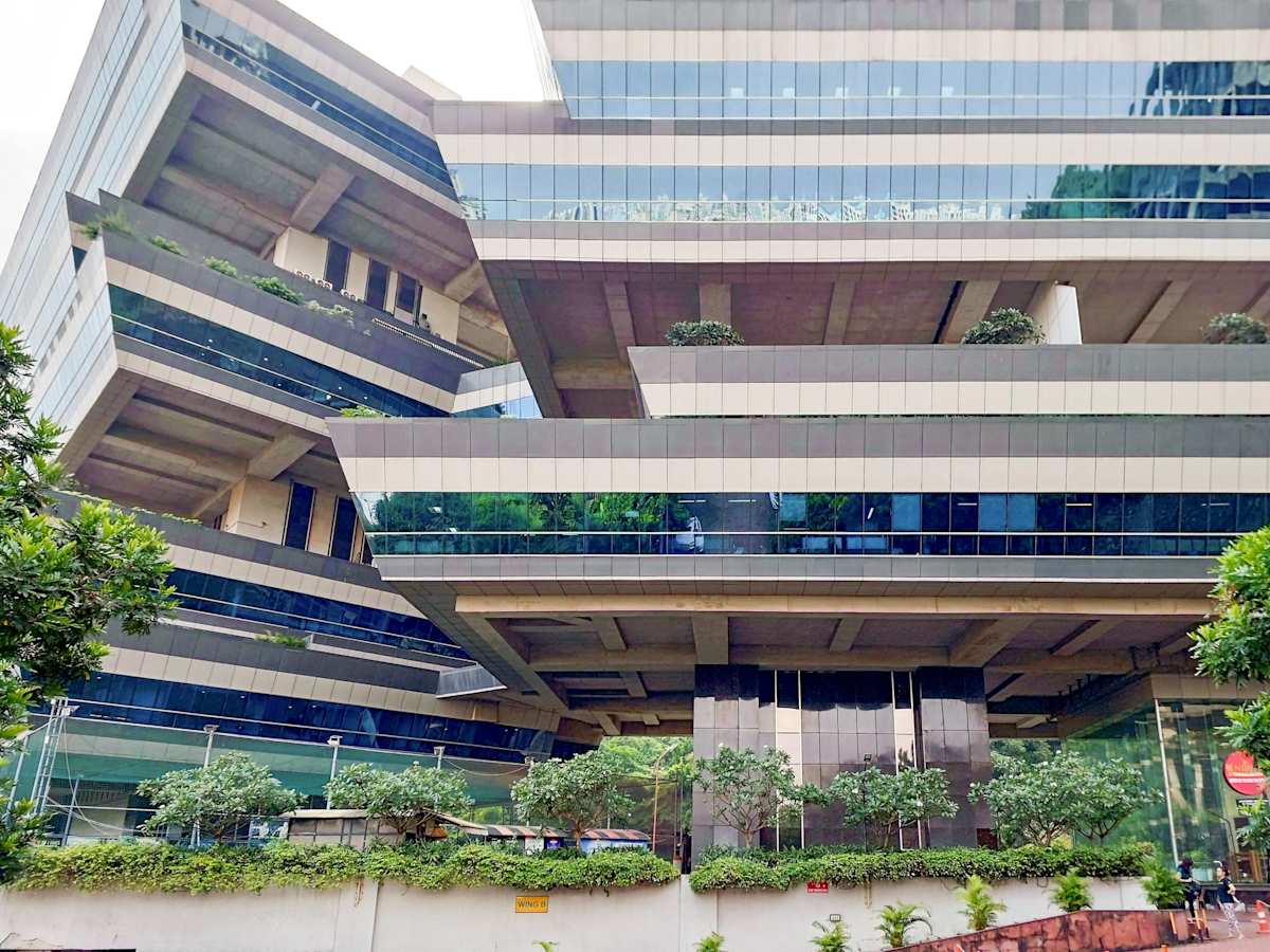 Dynamic coworking space in Mumbai with modern architecture and lush greenery.