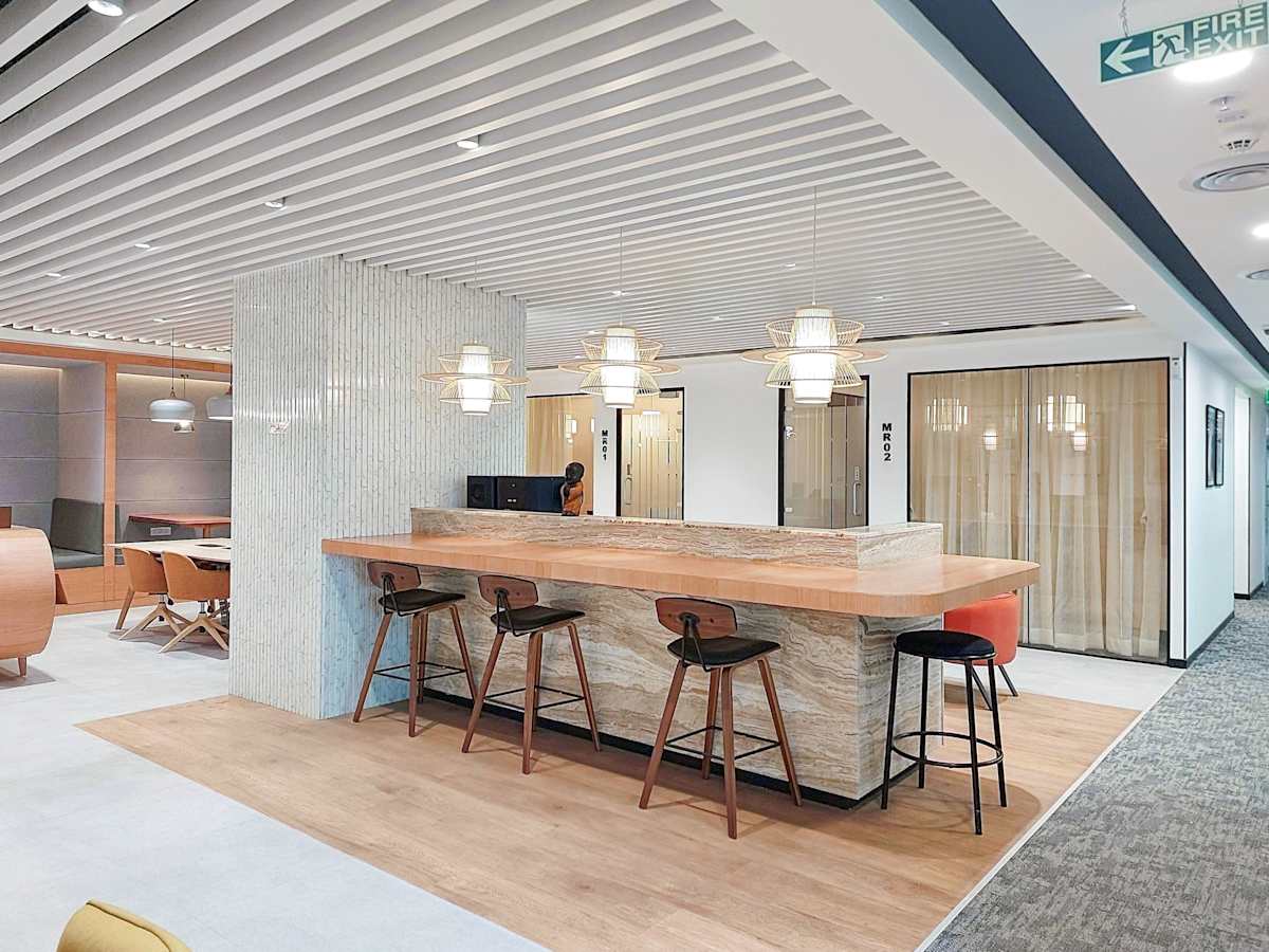 Sleek coworking space in Mumbai featuring a modern bar-style counter and ample natural lighting.