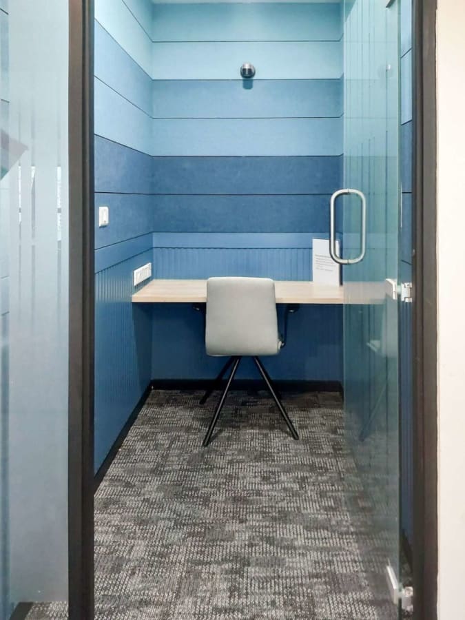 Private, modern workspace with vibrant blue walls, offering focus and comfort in a Mumbai coworking space.