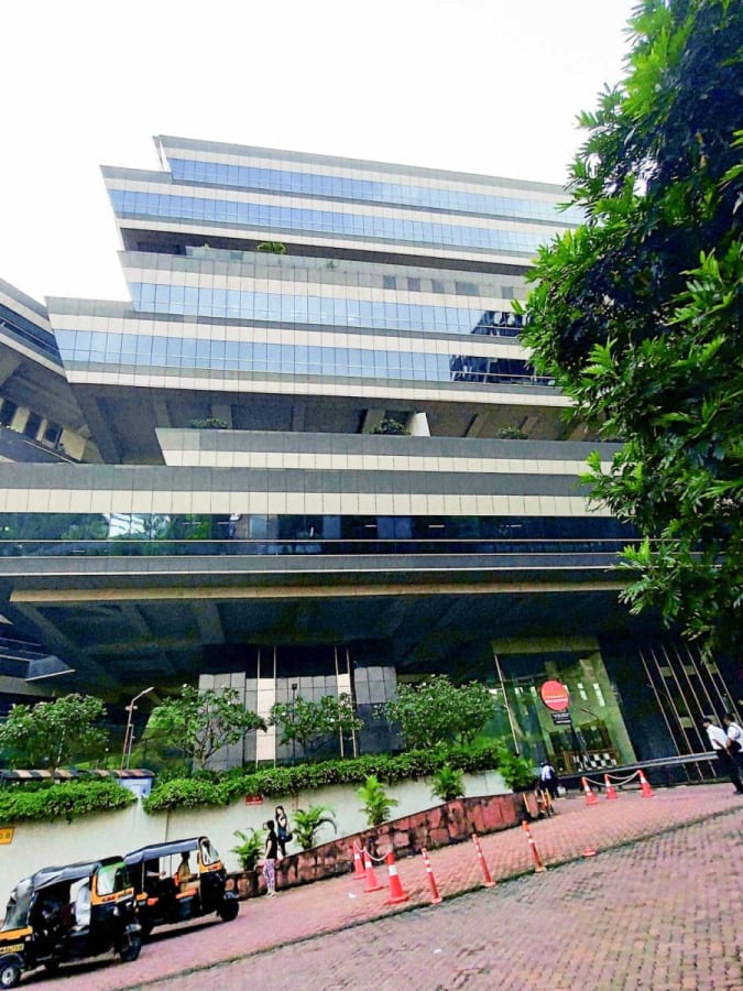 Modern coworking space in Mumbai, featuring sleek architecture and lush surroundings.