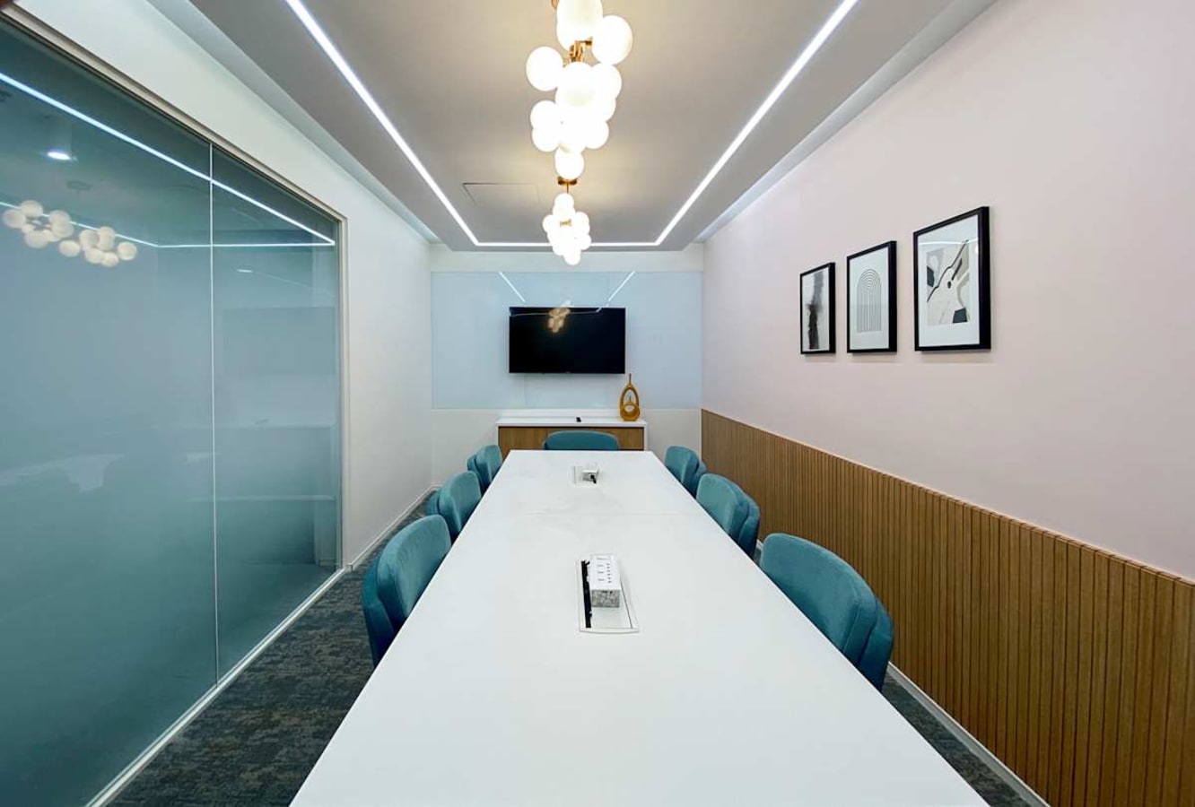Sleek meeting room with modern decor, ample seating, and advanced AV setup in Turbhe MIDC Road.