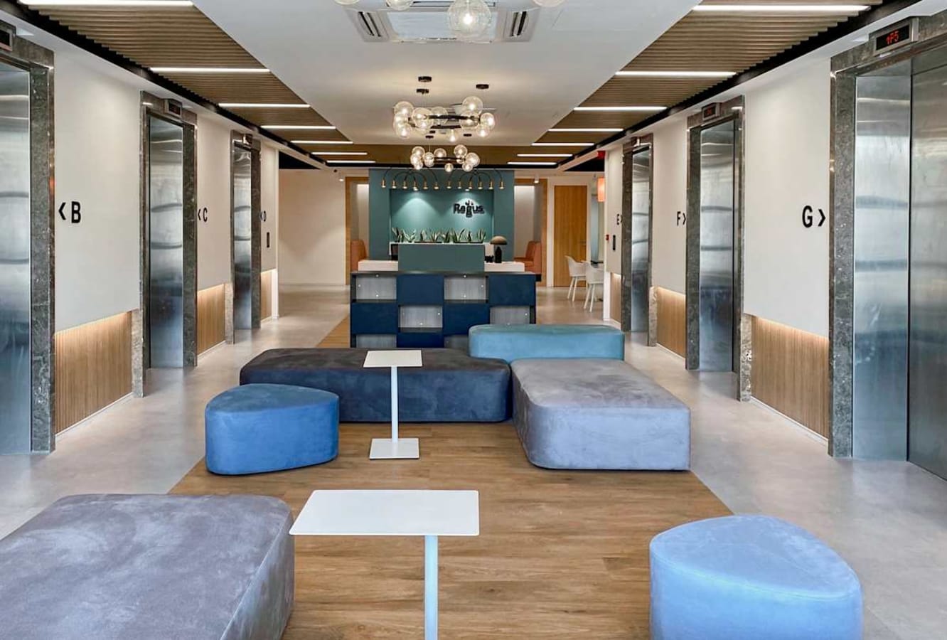 Modern coworking lounge with cozy seating, sleek elevators, and stylish lighting in Turbhe MIDC.