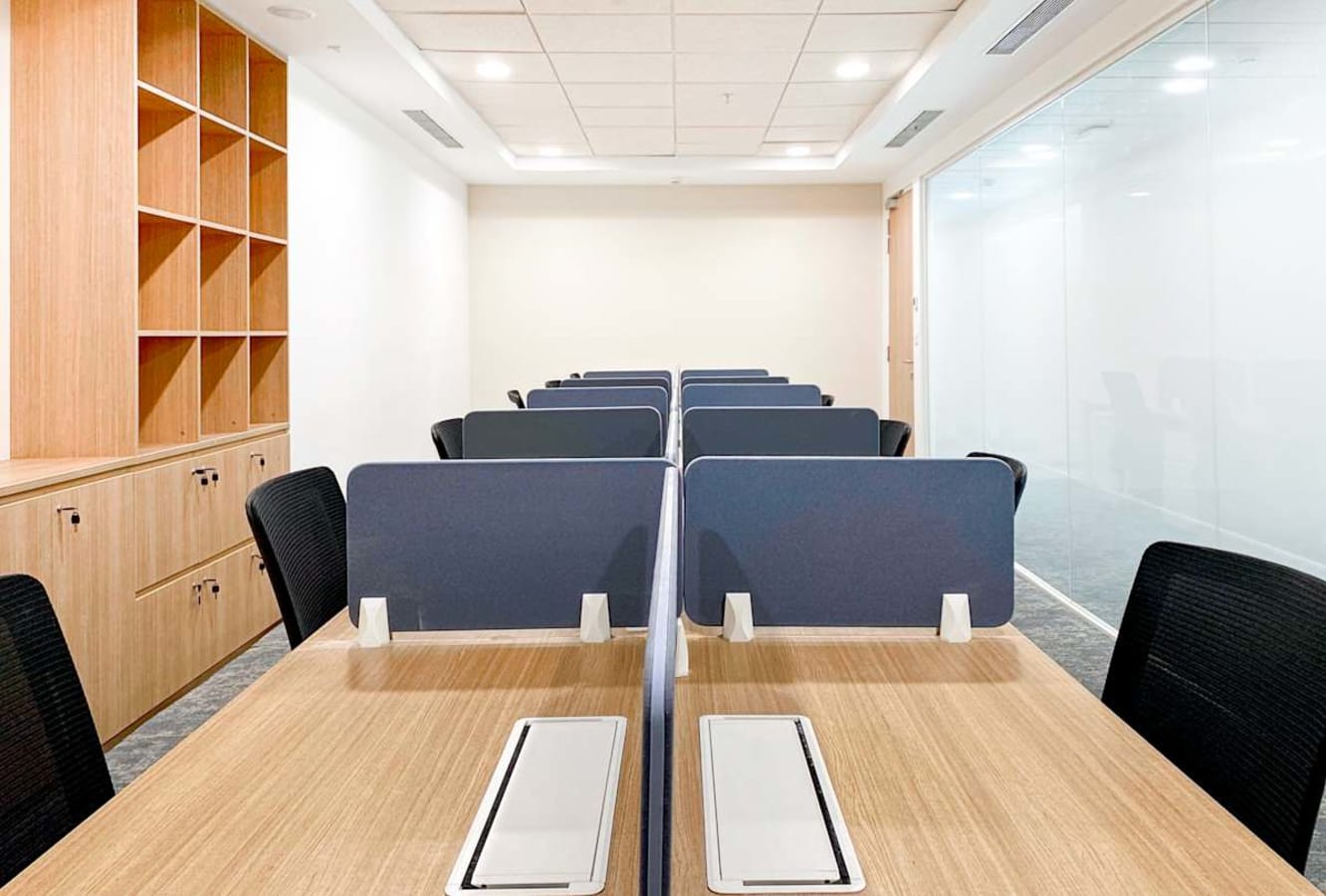 Modern coworking space with sleek desks, private dividers, and ample storage on Turbhe Midc Road.