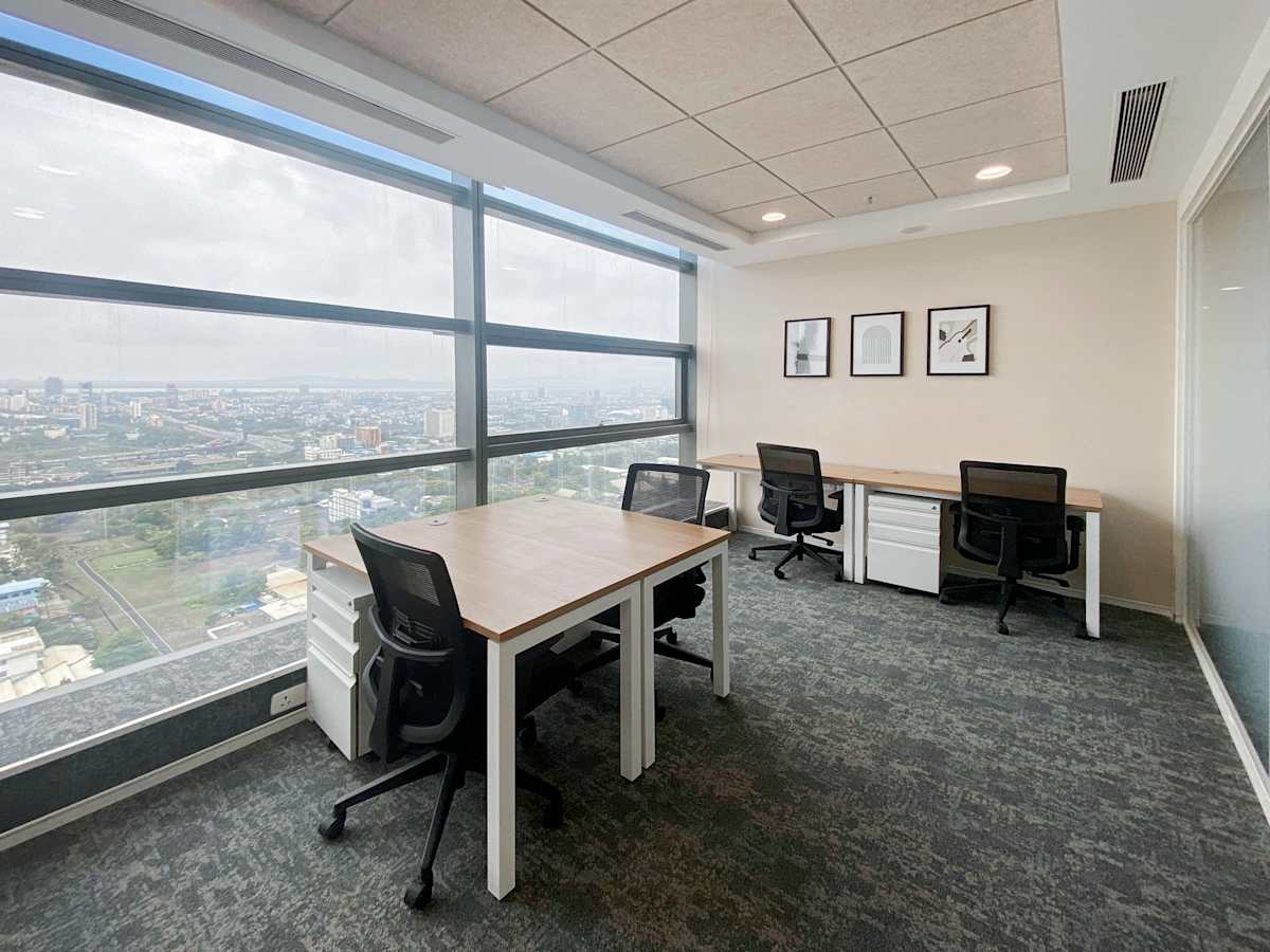 Bright, modern coworking space with large windows and expansive city views, perfect for productivity.