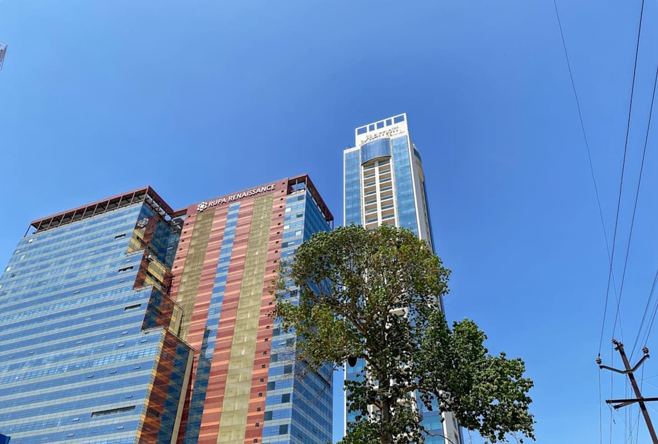 Modern coworking spaces in high-rise buildings on Turbhe MIDC Road, Maharashtra.