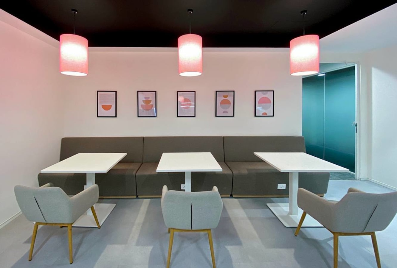 Modern coworking area with cozy seating, chic lighting, and stylish artwork in Turbhe.