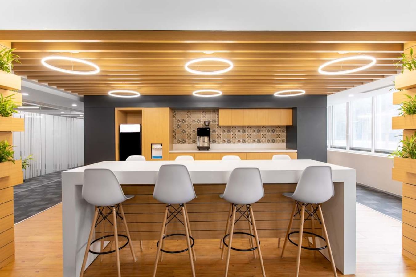 Modern coworking area with sleek wooden accents and ample natural light on Krishna Rajendra Road.