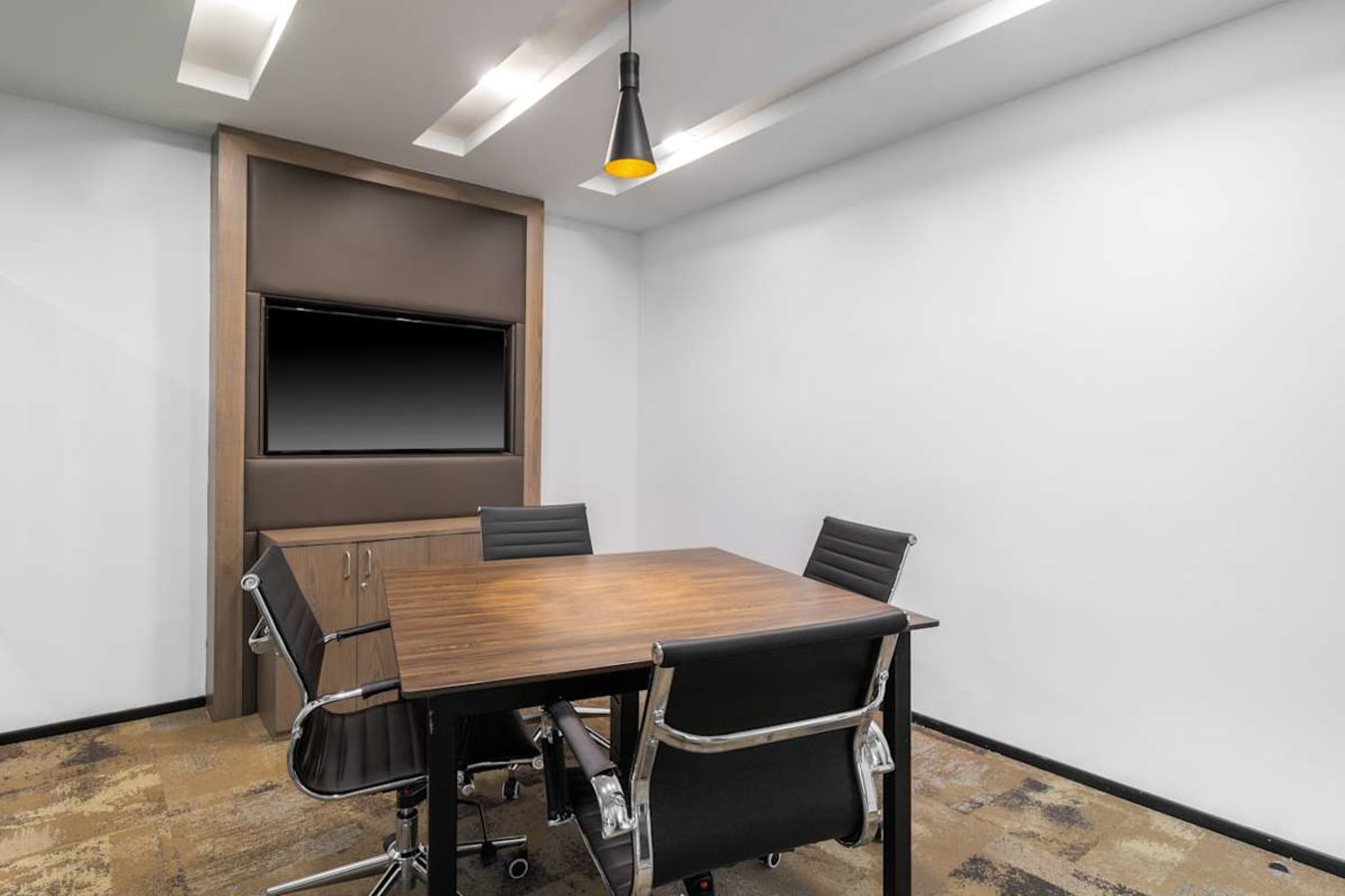 Modern meeting room with sleek furniture and ample lighting, ideal for collaboration.