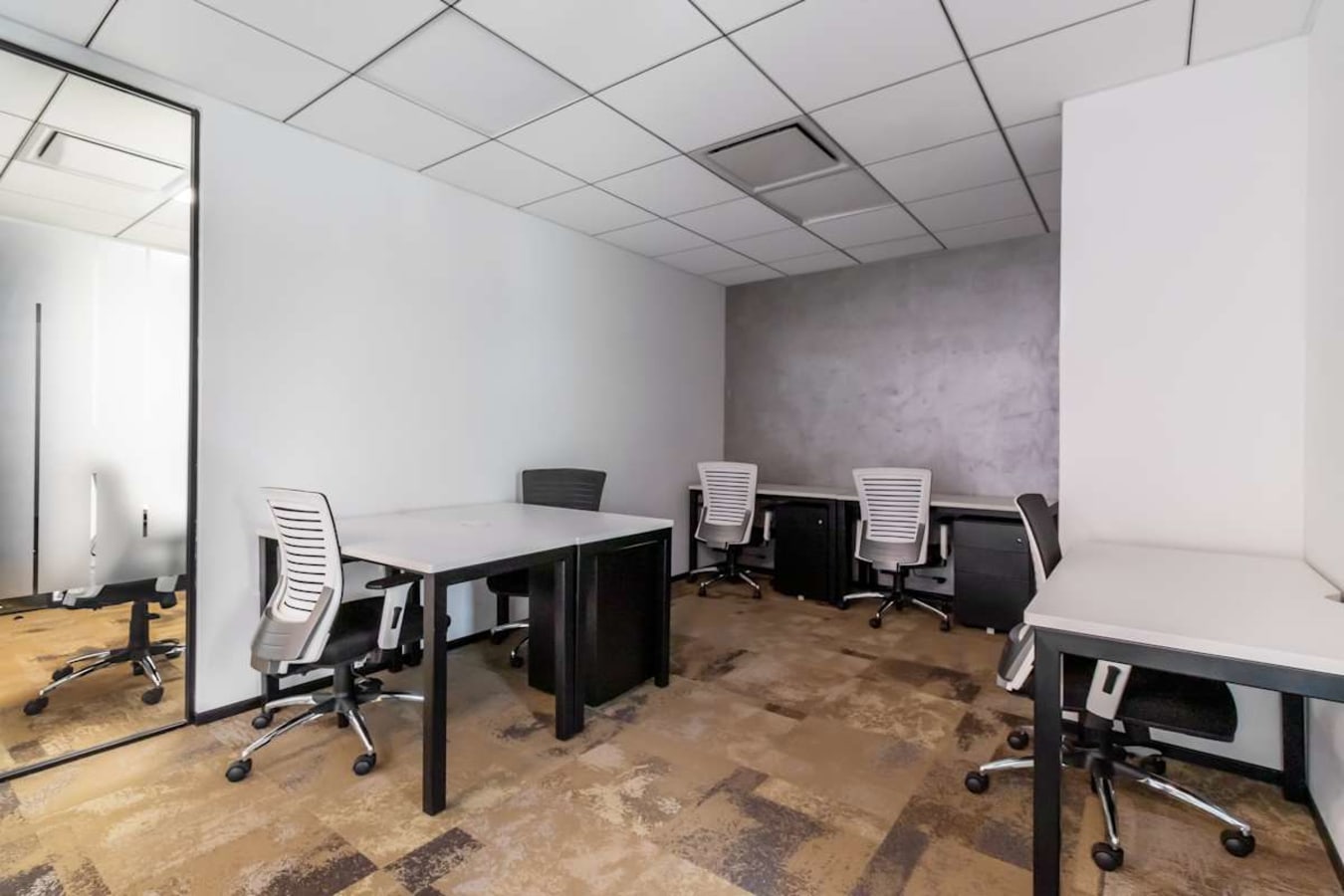 Modern coworking space with ergonomic chairs and ample desk space for productivity.