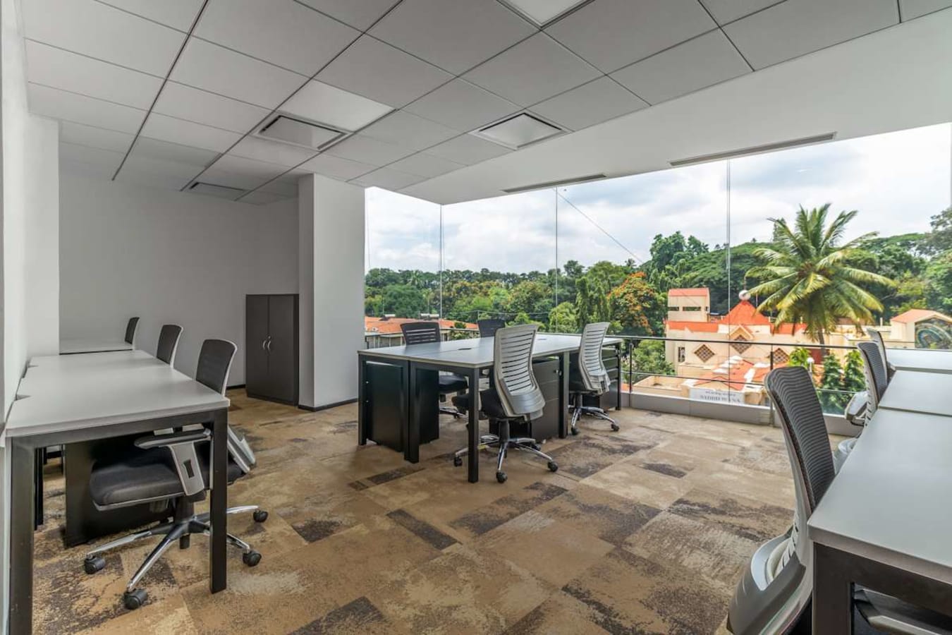 Spacious coworking area with natural light and scenic views on Doctor Rajkumar Road.