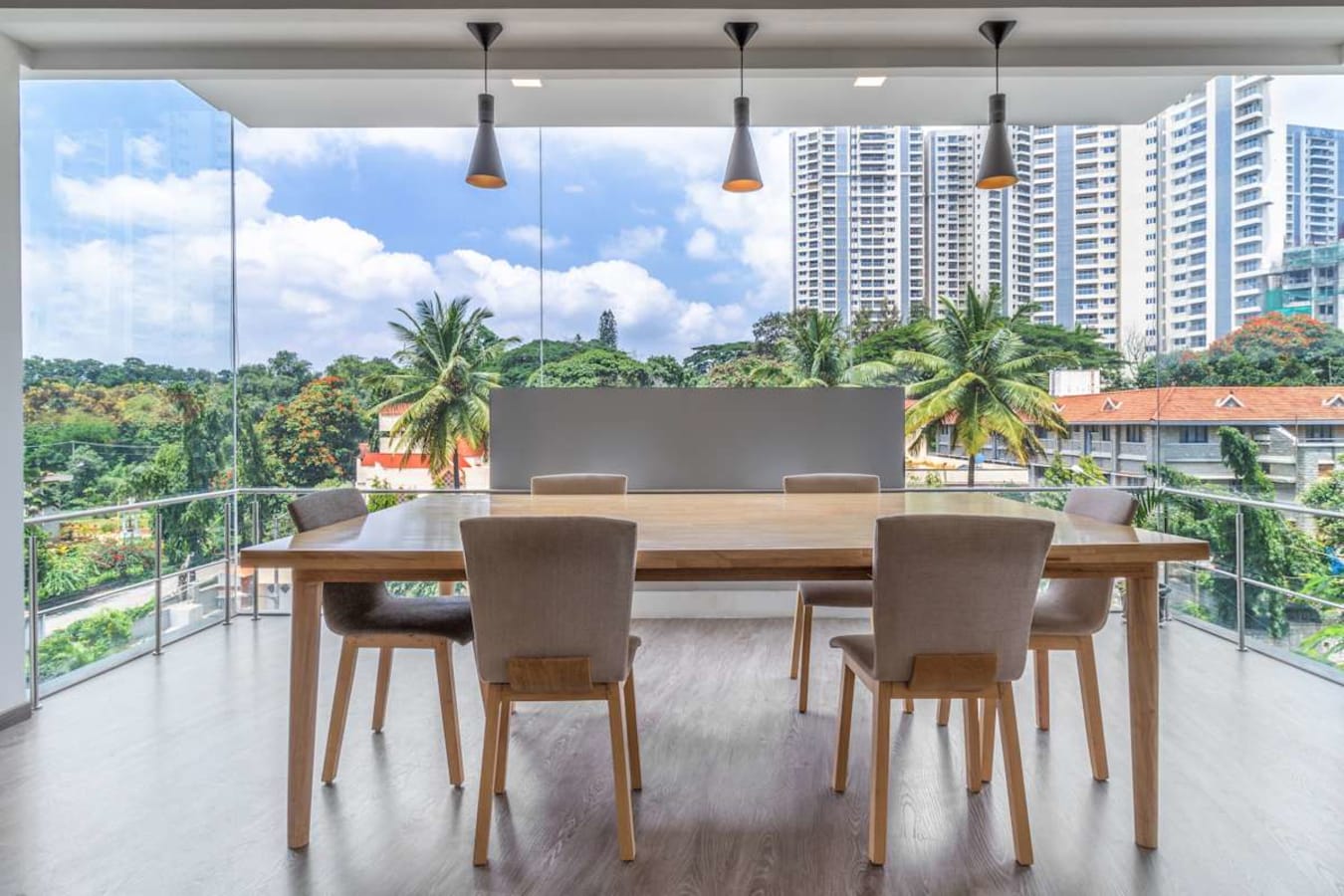 Modern coworking space with panoramic views, natural light, and stylish seating on Doctor Rajkumar Road.