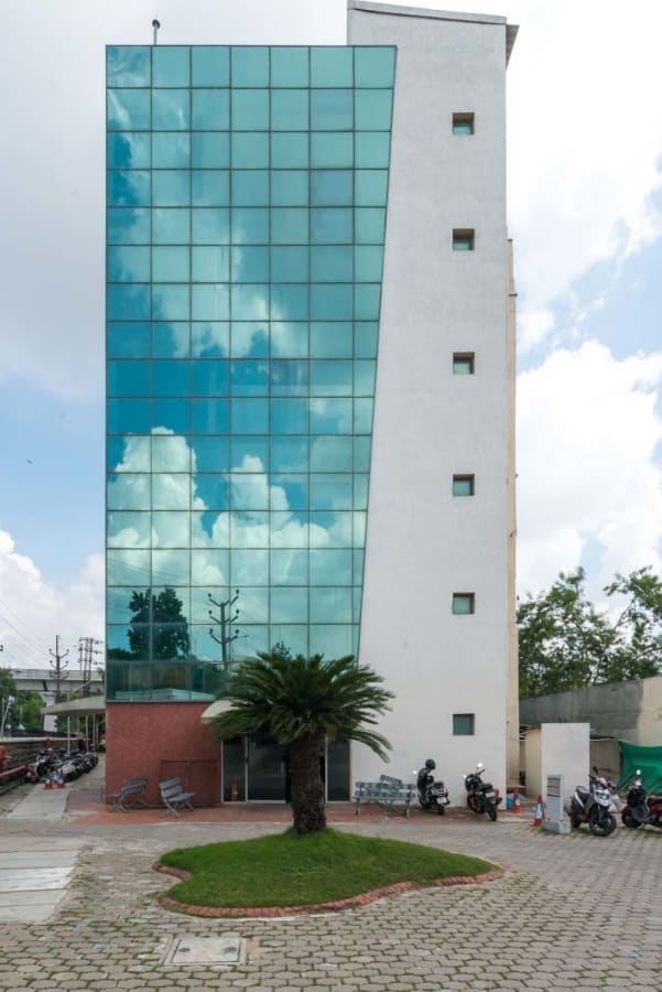Modern coworking space in a sleek building with glass facade, offering flexible office options.