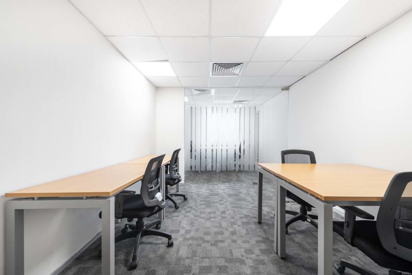 Modern coworking space with ample lighting and ergonomic seating on Genpact Road, Telangana.