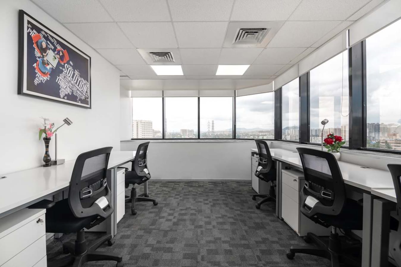 Bright, modern coworking space with ergonomic chairs and expansive city views. Ideal for productivity.