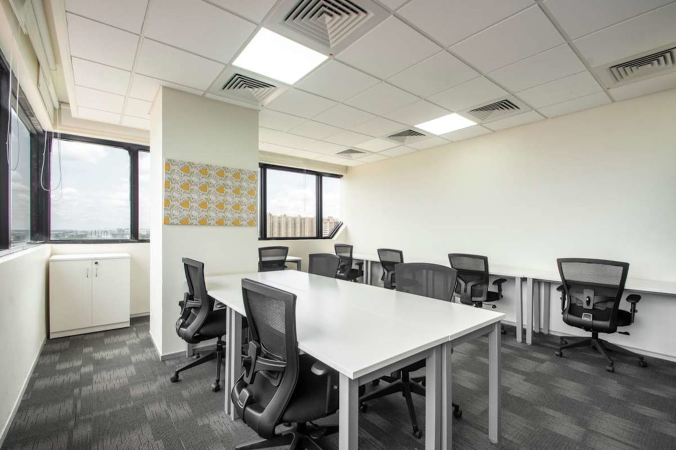 Modern coworking area with ergonomic chairs and natural lighting on Nallurhalli Road.