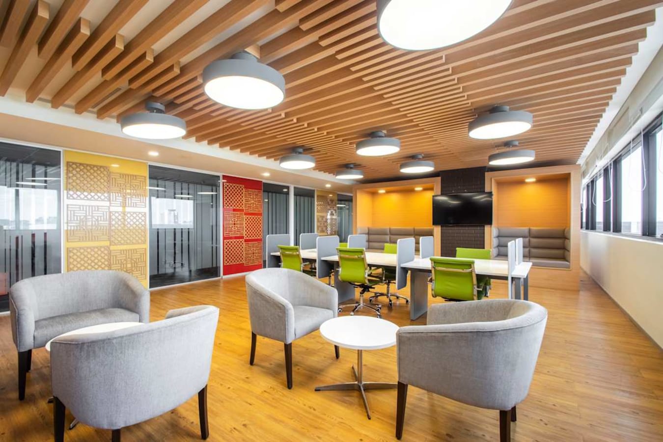 Modern coworking space with vibrant colors, comfortable seating, and ample natural light.