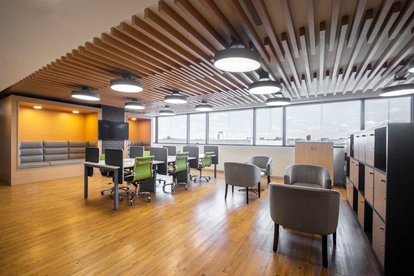 Modern coworking space with open seating, plush lounge, and natural light on Nallurhalli Road.