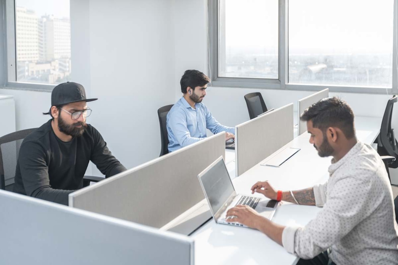 Modern coworking space with ample natural light and spacious workstations in Delhi's Phase 1.