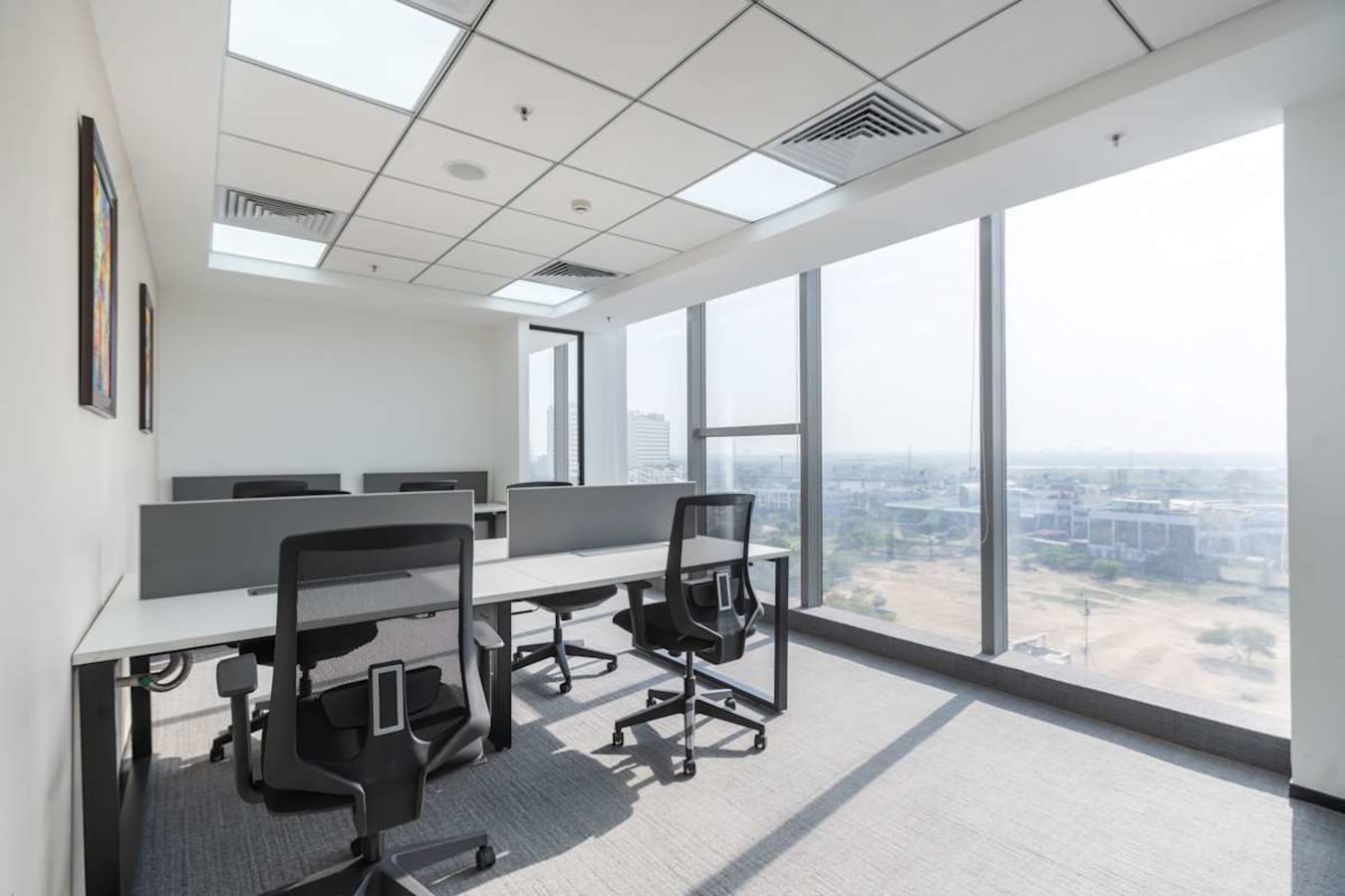 Bright coworking space in Phase 1, Delhi, featuring modern desks and panoramic views.