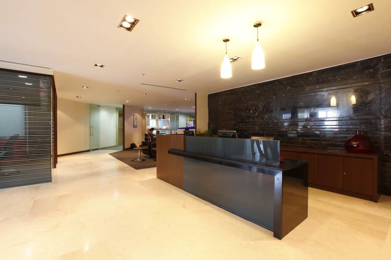 Sleek reception area with modern lighting and spacious layout in a flexible coworking space.