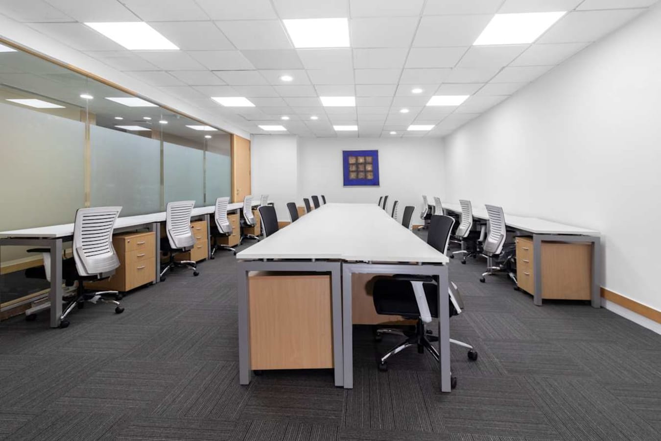 Spacious coworking area with ample seating, modern desks, and private offices. Ideal for collaboration.