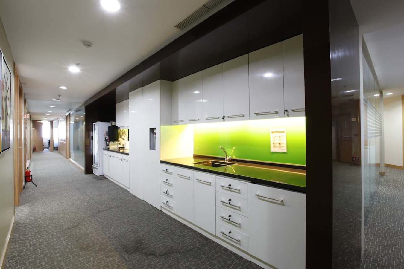Modern coworking space with sleek kitchen amenities on Vittal Mallya Road.