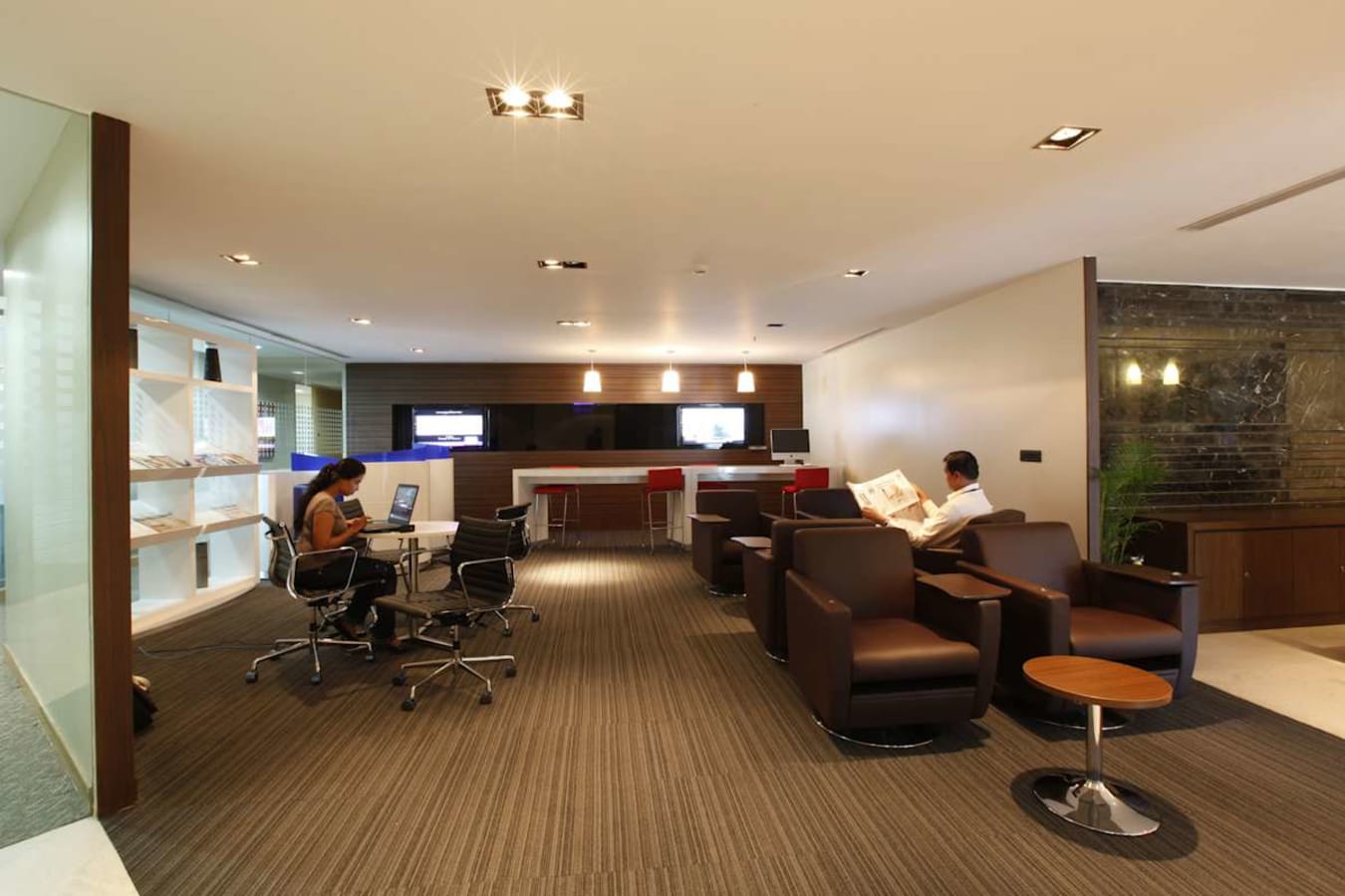 Modern coworking space on Vittal Mallya Road featuring cozy seating, workstations, and sleek design.