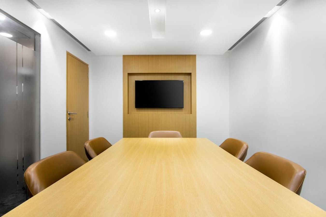 Modern meeting room with sleek design, ample seating, and a wall-mounted screen in Camac Street.
