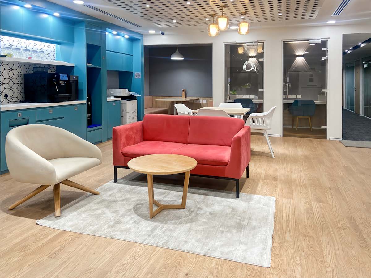 Modern coworking space with vibrant seating, ample lighting, and a stylish communal area.