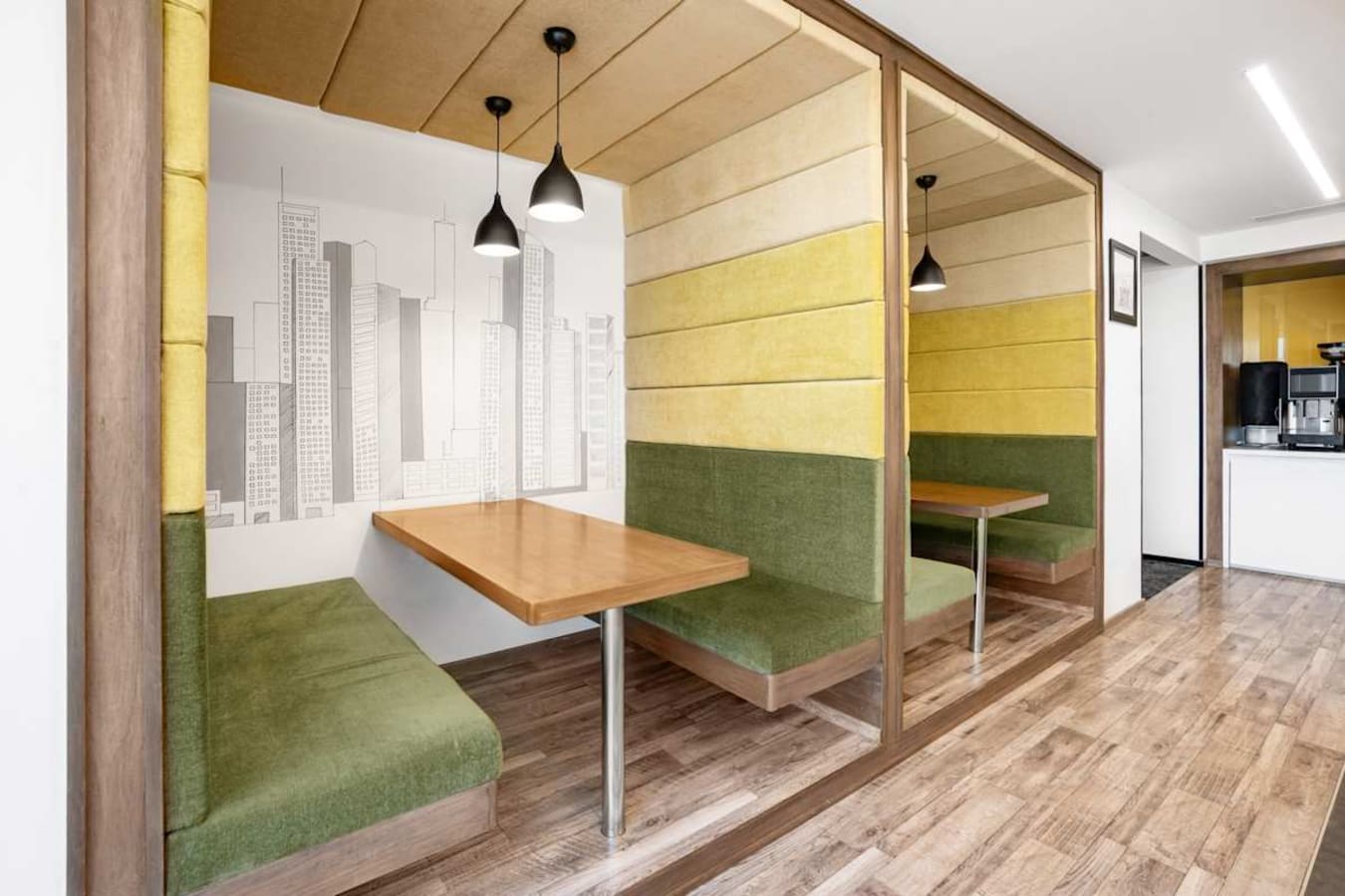 Stylish booth seating with urban decor, ideal for focused work or collaborative meetings.