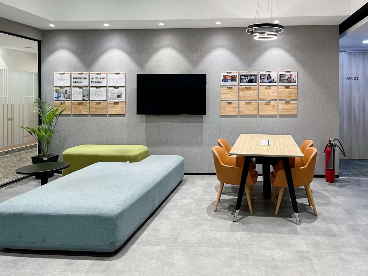 Modern coworking space in Gurugram with sleek seating, collaborative table, and bright lighting.