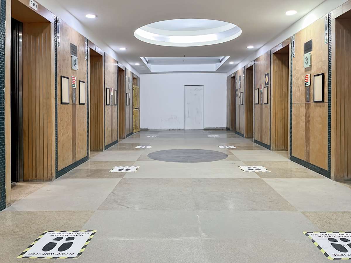 Modern coworking space lobby in Gurugram with sleek elevator access. Ideal for businesses.
