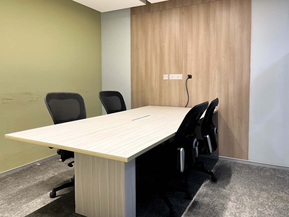 Modern meeting room with sleek chairs and a spacious table, perfect for collaborative work.