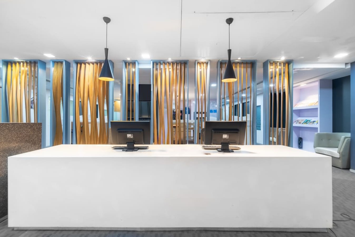 Modern coworking space with sleek reception, stylish lighting, and vibrant decor on Annie Besant Road.