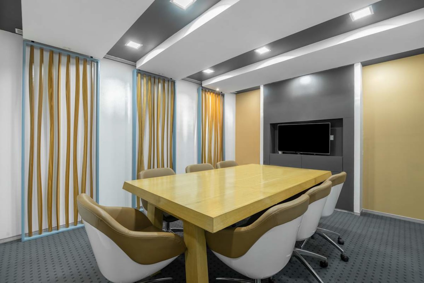 Modern conference room with sleek decor, ample seating, and advanced presentation technology.
