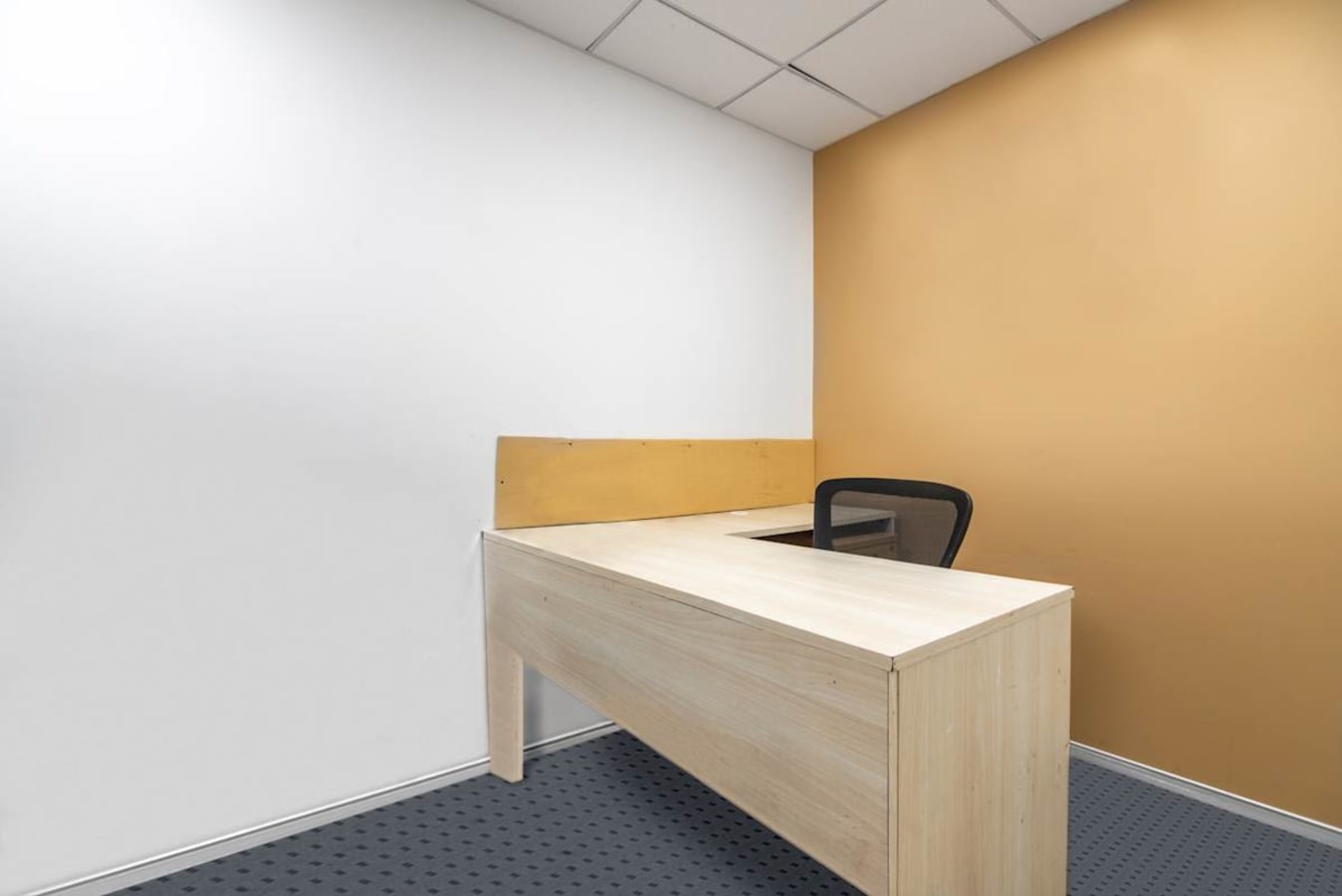 Minimalist workspace with natural light and modern furnishings on Doctor Annie Besant Road.