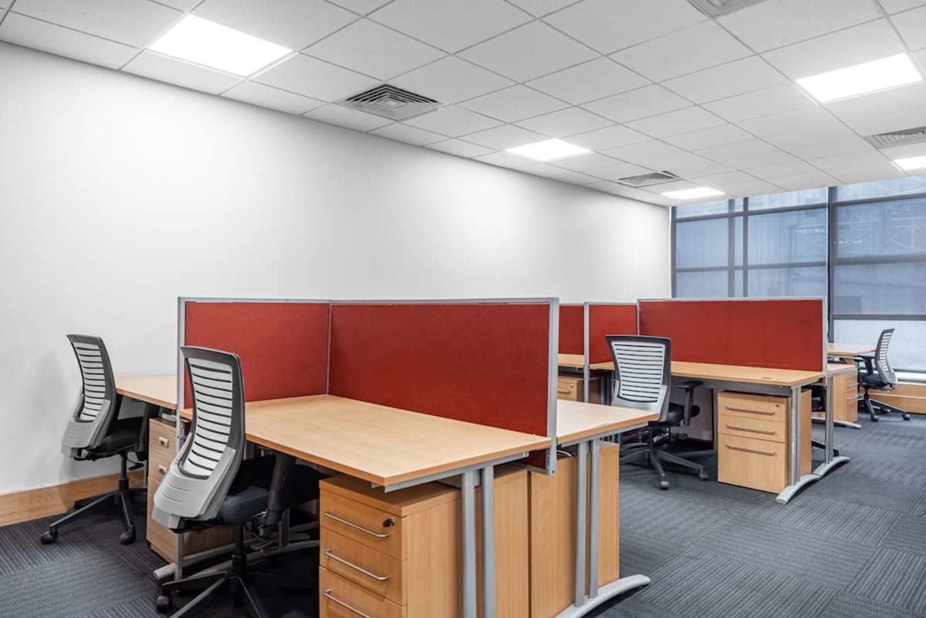 Modern coworking space with ergonomic chairs and private desks near Jalagam Vengala Rao Park.