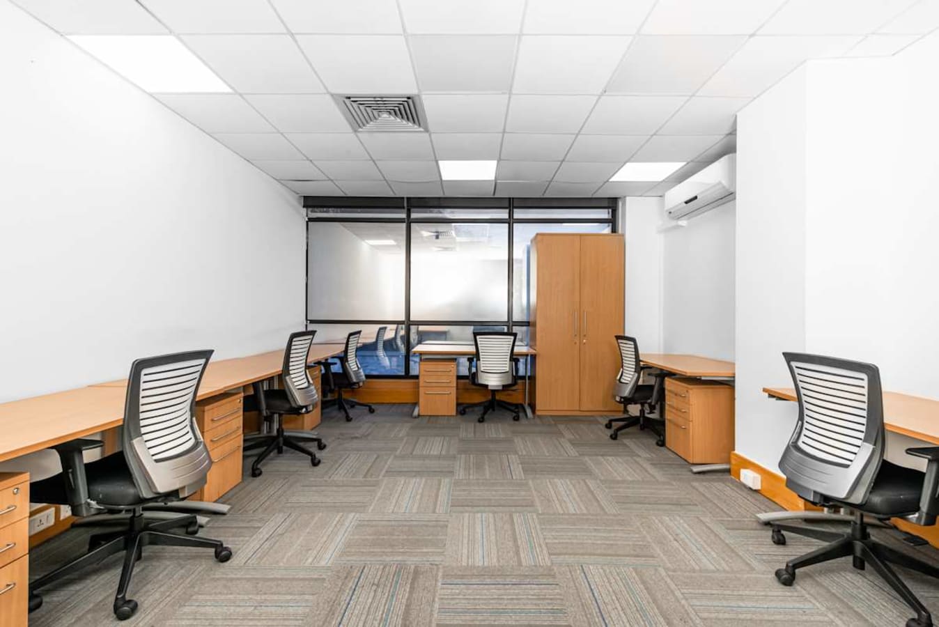 Spacious coworking area with modern chairs and ample desk space, perfect for productive work.
