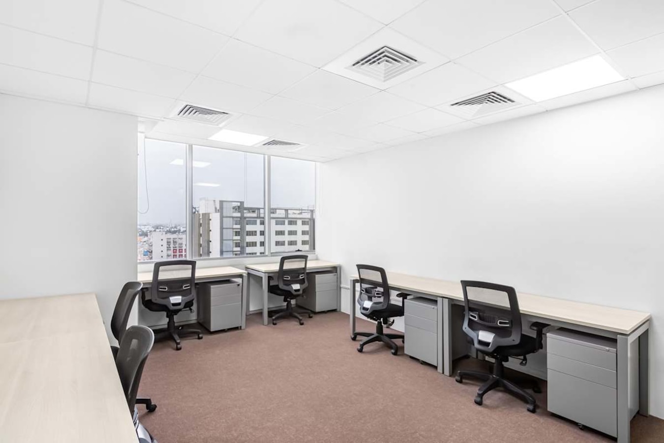 Bright, modern workspace with ergonomic chairs and abundant natural light in South Phase.