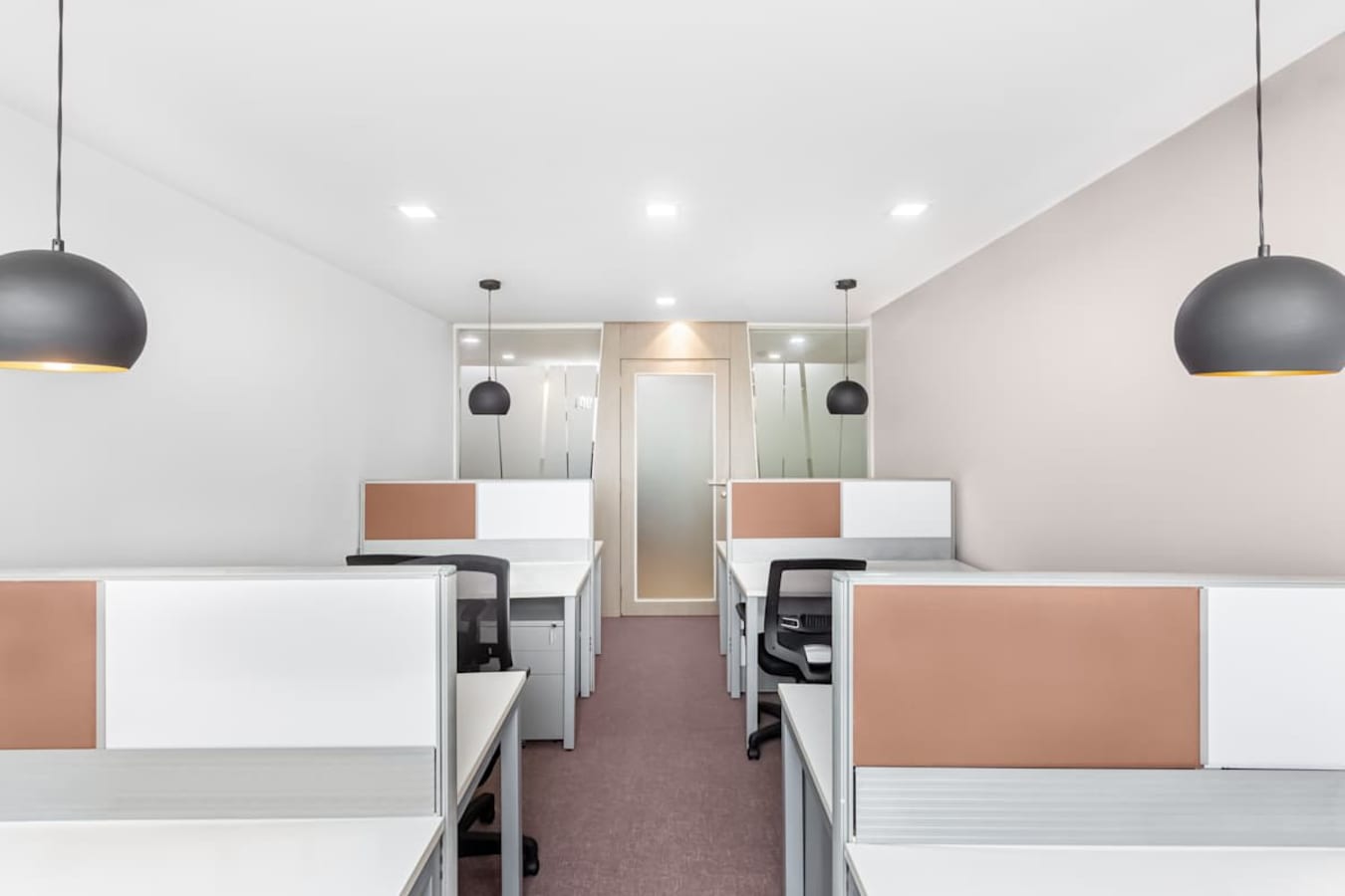 Bright, modern coworking space with sleek workstations and stylish lighting in South Phase.