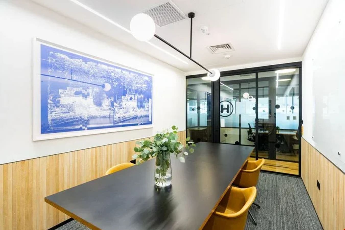 Modern meeting room with sleek table, stylish chairs, and elegant decor at Robinson Road coworking space.