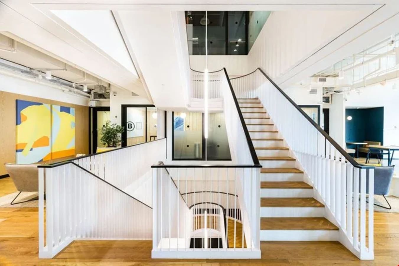 Bright, modern coworking space with an elegant staircase and open layout in Robinson Road, Singapore.